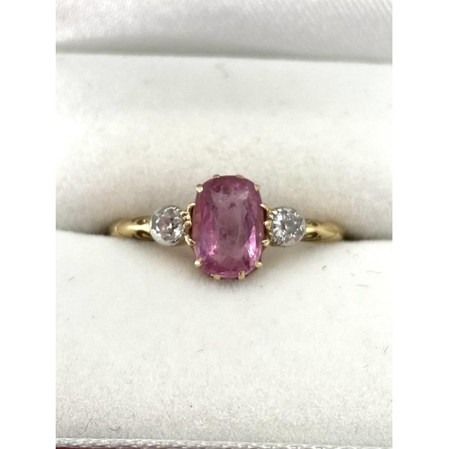 95 - An 18ct gold fancy pink sapphire and diamond ring, central oval free cut sapphire with old brilliant... 