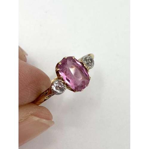 95 - An 18ct gold fancy pink sapphire and diamond ring, central oval free cut sapphire with old brilliant... 