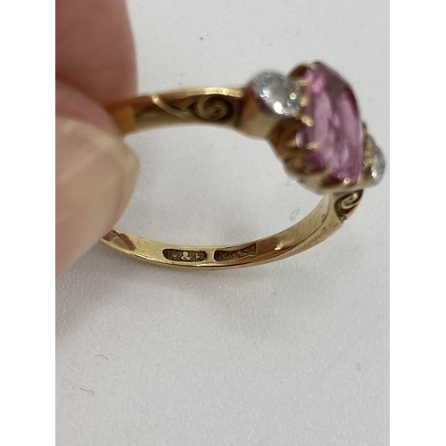 95 - An 18ct gold fancy pink sapphire and diamond ring, central oval free cut sapphire with old brilliant... 