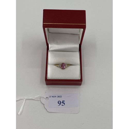 95 - An 18ct gold fancy pink sapphire and diamond ring, central oval free cut sapphire with old brilliant... 