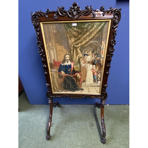 569 - A good large Victorian carved mahogany fire screen inset with glazed needlepoint of a Cromwellian sc... 