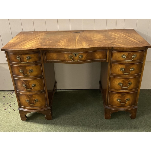 579 - Kidney shaped kneehole desk with central drawer, and 4 drawers to each side, much wear to top