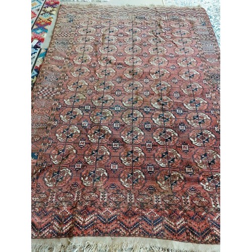 744 - A large terracotta ground rug. 208 x 315cm, SOME RESTORATION NEEDED