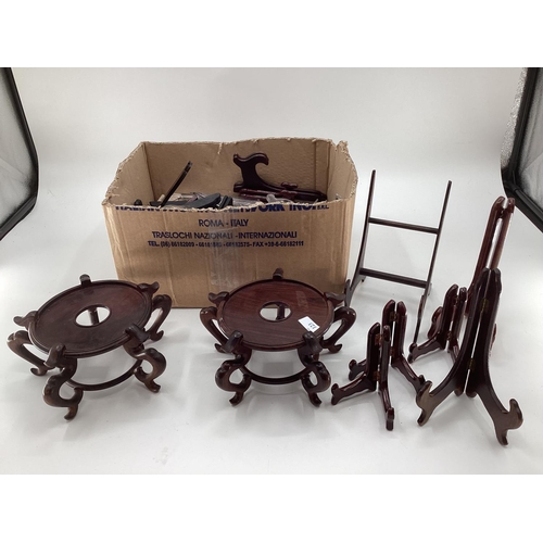 123 - Collection of oriental hardwood stands, and lamp bases, and a quantity of plastic stands