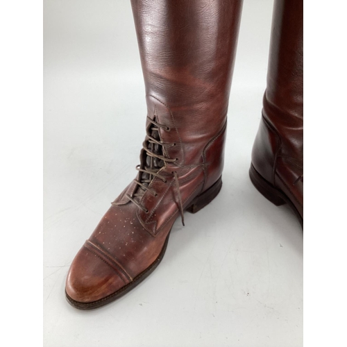 132 - Pair of  brown leather laced riding boots, with trees. Sole is 27.75cm
Length os psine of back all w... 