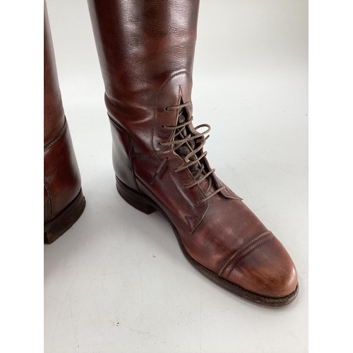 132 - Pair of  brown leather laced riding boots, with trees. Sole is 27.75cm
Length os psine of back all w... 