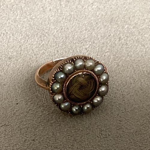 18 - A C19th 9ct gold mourning ring, central quartz panel with a surround of split pearls, 3.8g