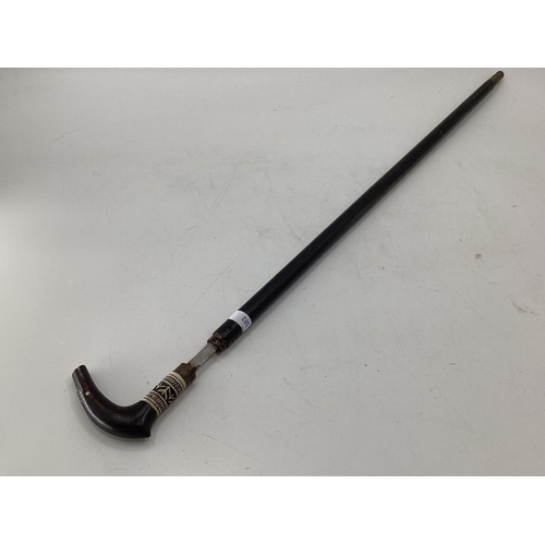 202 - An ebonised and bone sword stick with brass fittings 92cm