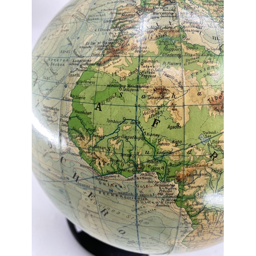 216 - A mid century JRO globus, Munich, illuminated globe on turned ebonised stand, 38cmH