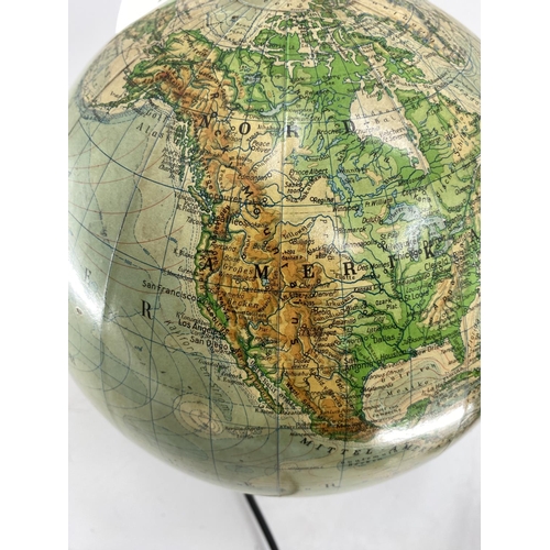 216 - A mid century JRO globus, Munich, illuminated globe on turned ebonised stand, 38cmH