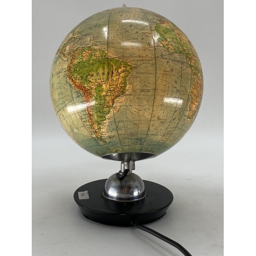 216 - A mid century JRO globus, Munich, illuminated globe on turned ebonised stand, 38cmH