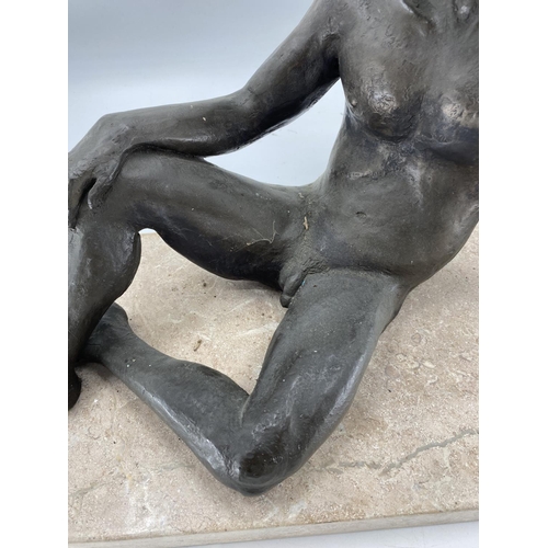 220 - A bronzed effect reclining nude gentleman on a rectangular marble base, 50 x 24 x 38cm H