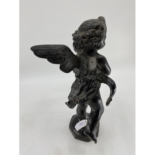 221 - An Italian bronze  water feature of a winged cherub carrying a dolphin, on an octagonal domed base a... 