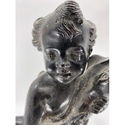 221 - An Italian bronze  water feature of a winged cherub carrying a dolphin, on an octagonal domed base a... 