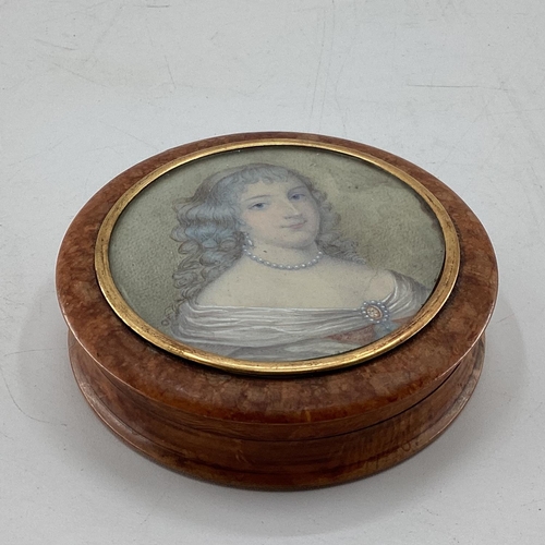 230 - A circular walnut table snuff box, the cover set with a portrait of an C18th lady with yellow metal ... 