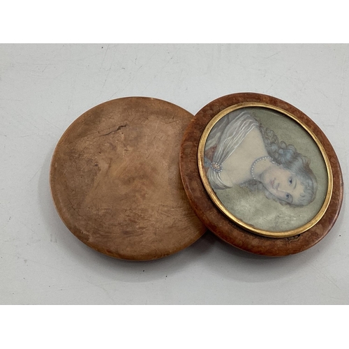 230 - A circular walnut table snuff box, the cover set with a portrait of an C18th lady with yellow metal ... 