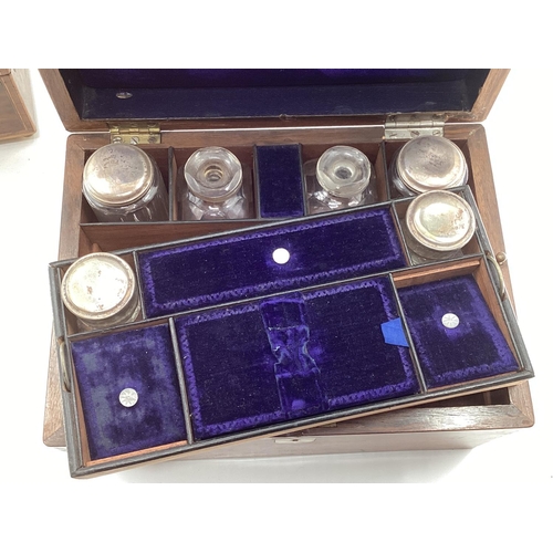 232 - A Victorian travelling dressing set fitted interior with white metal topped glass items and secret d... 