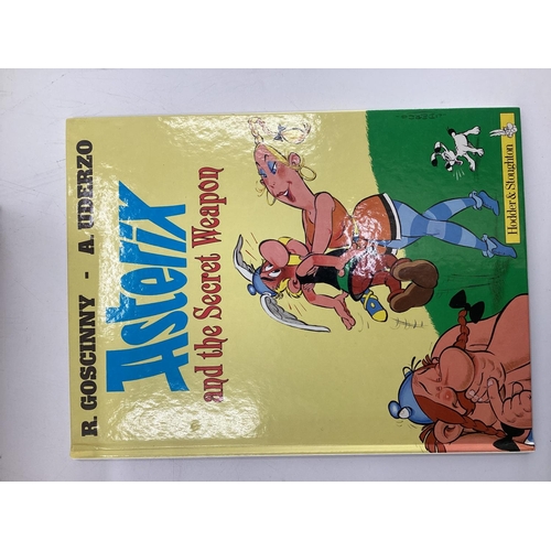 235 - A large collection of Paperback Tin Tin and Asterix books