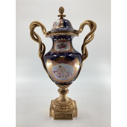 249 - Meissen style lidded urn with gilt brass base and finial, gilt brass entwined snake handles, hand pa... 