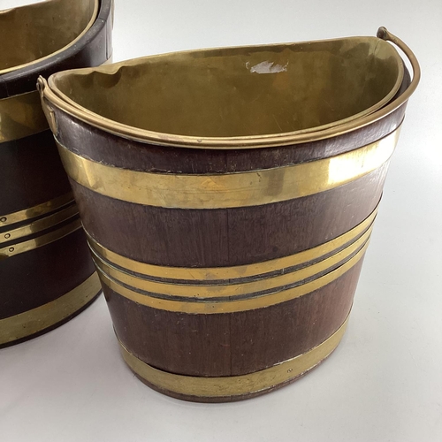 259 - Two late C19th oval mahogany brass bound peat buckets, with brass lined interiors and loop handles, ... 