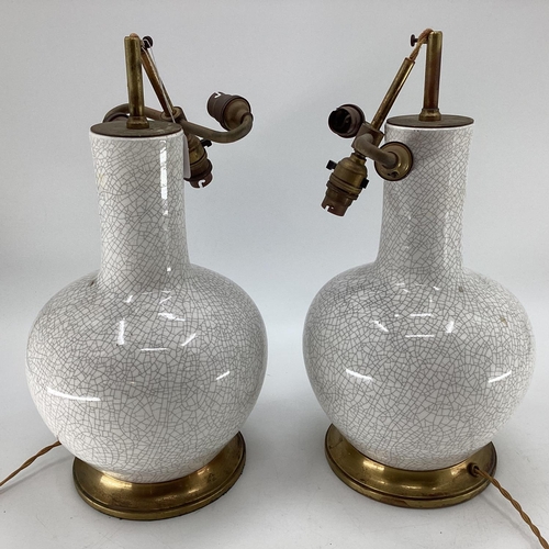 273 - A pair of bulbous white and all over crackle glaze table lamps, with brass style base and fittings f... 