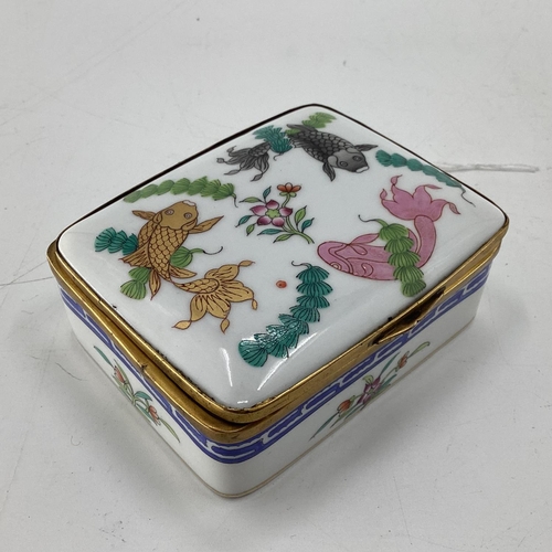 278 - A Herend Bonbonniere trinket box, with brass hinged lid, decorated foliage and fish; and a pair of c... 