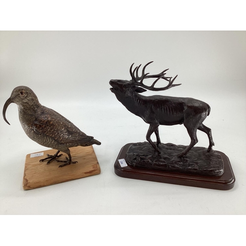 280 - A modern decorative bronze style model of a red stag, mounted on wooden plinth, 27cm H x 30cm W over... 