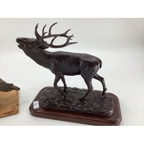 280 - A modern decorative bronze style model of a red stag, mounted on wooden plinth, 27cm H x 30cm W over... 