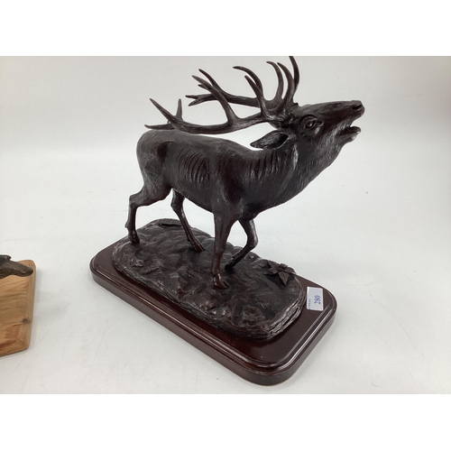 280 - A modern decorative bronze style model of a red stag, mounted on wooden plinth, 27cm H x 30cm W over... 