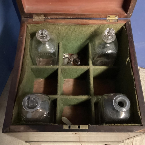 312 - A mahogany square and fitted decanter box on raised legs, with brass handles to each side, as found