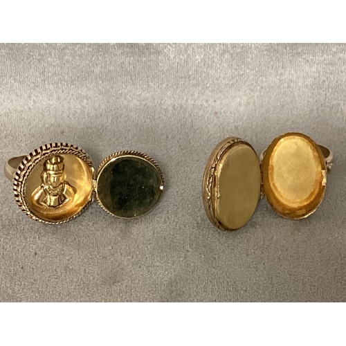 33 - Two unmarked yellow metal poison rings, one set with amber, and one with turquoise cabochon, each op... 