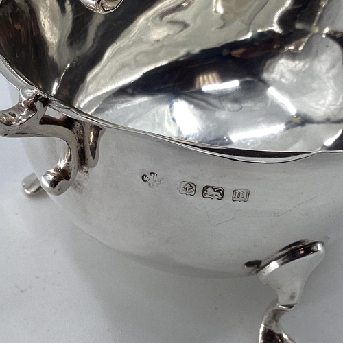 45 - A collection of sterling silver items to include toast rack, sauce boat, and other items