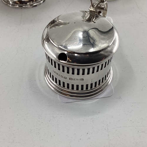 46 - A pair of sterling silver pepperettes, a small mustard and a German white metal sugar shaker