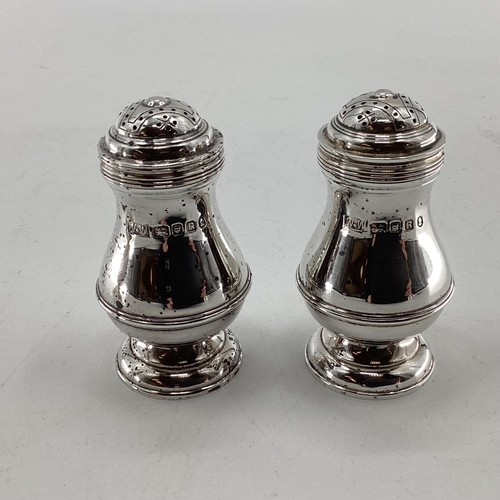 46 - A pair of sterling silver pepperettes, a small mustard and a German white metal sugar shaker