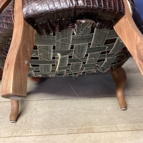 516 - An early C20th walnut tub chair with faux crocodile skin upholstery, 74cmH