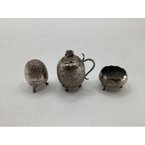 54 - A South Asian white metal condiment set and tray together with other similar items