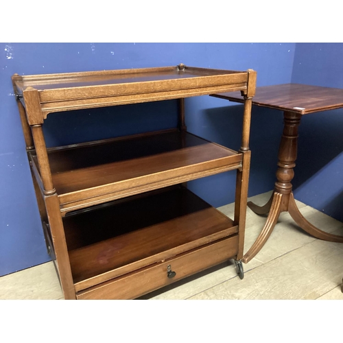 542 - Small mahogany two tier buffet with drawer below, on wheels, and a fold over table, a fall flap occa... 