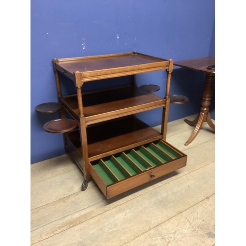 542 - Small mahogany two tier buffet with drawer below, on wheels, and a fold over table, a fall flap occa... 