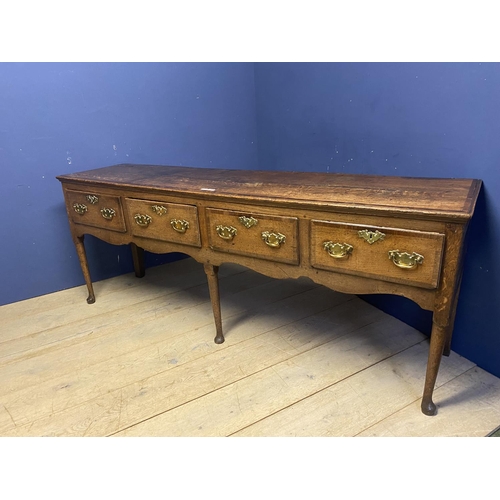 558 - A good oak dresser base, with four drawers and brass handles, 216 x 51cm, some wear and old splits e... 