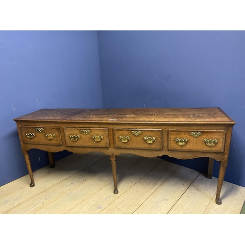 558 - A good oak dresser base, with four drawers and brass handles, 216 x 51cm, some wear and old splits e... 