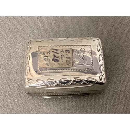 91 - A sterling silver vinaigrette, chased decoration, fitted gilt metal interior, stamped TS Birmingham,... 