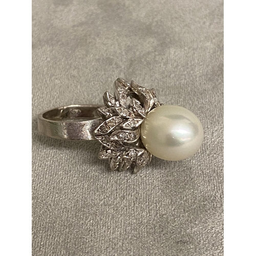 4 - An 18c white gold, pearl and diamond ring, central single pearl, approx 12mm set with double surroun... 