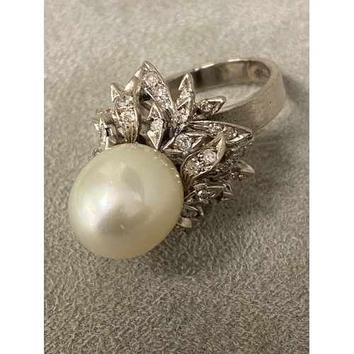 4 - An 18c white gold, pearl and diamond ring, central single pearl, approx 12mm set with double surroun... 