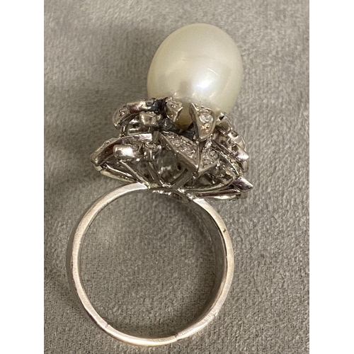 4 - An 18c white gold, pearl and diamond ring, central single pearl, approx 12mm set with double surroun... 