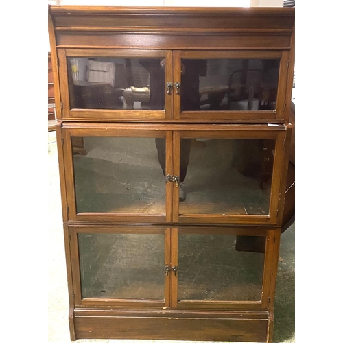 540 - A Globe Werneke  style three tier glazed narrow book case with glazed doors 132Hx 85W x 28D