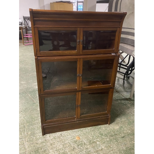 540 - A Globe Werneke  style three tier glazed narrow book case with glazed doors 132Hx 85W x 28D