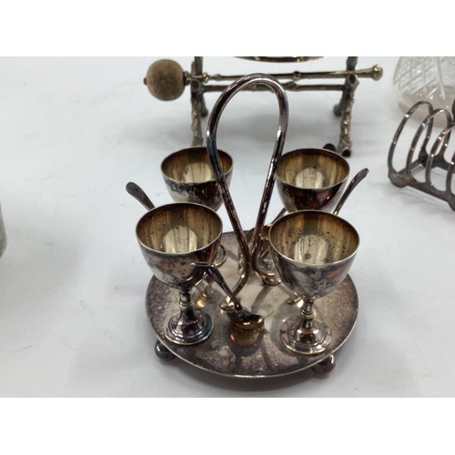 77 - Quantity of silver plate to include toast rack, ice bucket, gong, etc