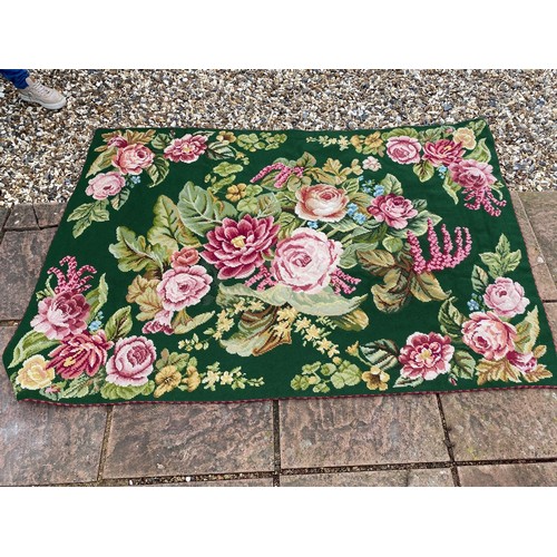 347 - A tapestry rug, with green ground and pink roses