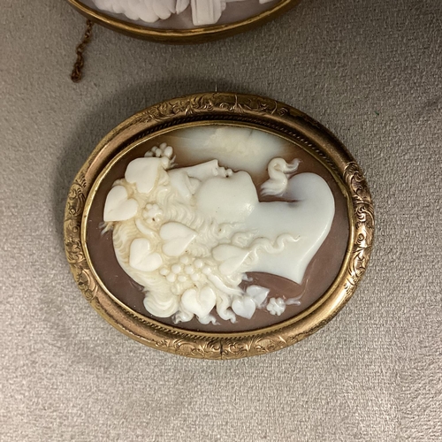 10 - Two unmarked yellow metal mounted shell cameo brooches, and a white metal and paste monkey brooch