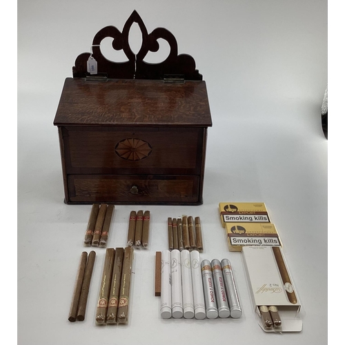 106 - An oak hanging candle box, with single drawer, below containing a mixed selection of cigars, Davidof... 